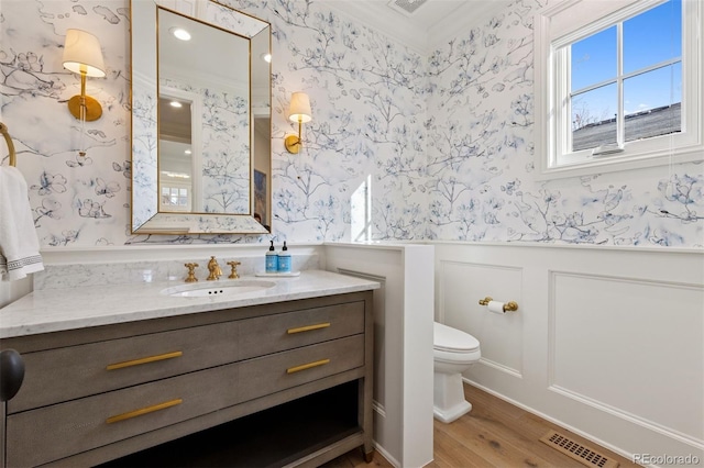 2130 S Milwaukee St, Denver, CO 80210 - bathroom featuring vanity, visible vents, a wainscoted wall, wallpapered walls, and toilet