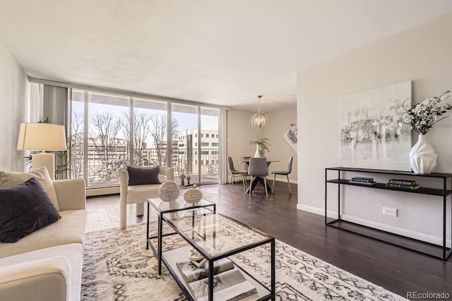 living room featuring dark wood-style flooring, a wall of windows, and baseboards