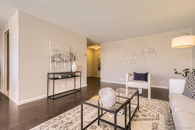 living room with baseboards and dark wood-style flooring