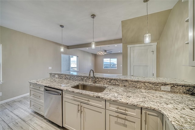 kitchen featuring sink, stainless steel dishwasher, light stone countertops, light wood-type flooring, and decorative light fixtures