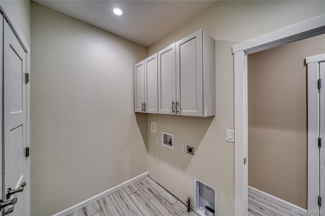 laundry area with cabinets, hookup for a washing machine, light wood-type flooring, and electric dryer hookup