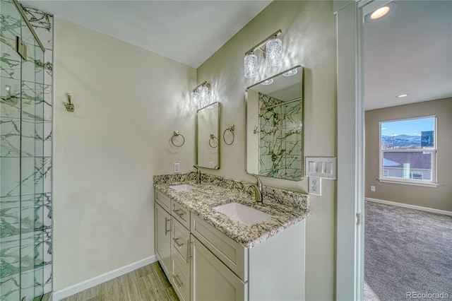 bathroom with vanity and a shower with shower door