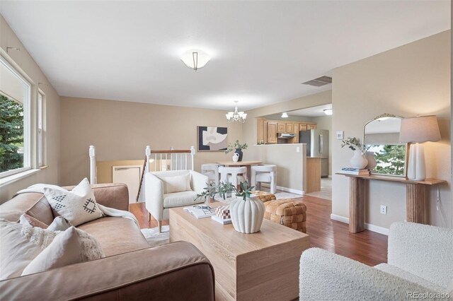 30321 Chestnut Dr, Evergreen, CO 80439 - living room with a chandelier, light wood-style floors, and baseboards