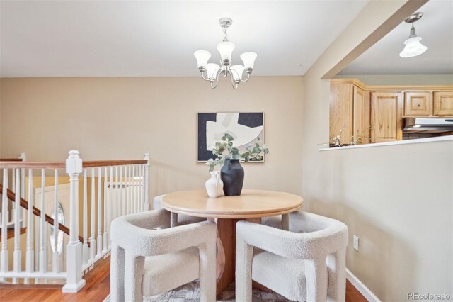 30321 Chestnut Dr, Evergreen, CO 80439 - dining space featuring a chandelier, light wood finished floors, and baseboards