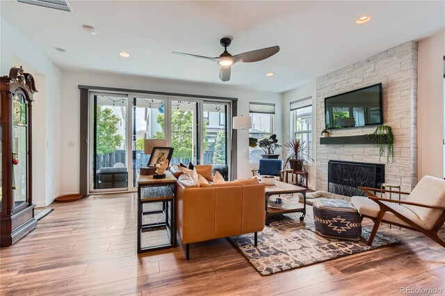 11253 Moondance Trl, Littleton, CO 80125 - living room with plenty of natural light, a fireplace, hardwood / wood-style flooring, ceiling fan, and recessed lighting