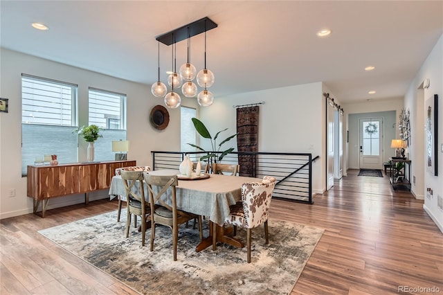 11253 Moondance Trl, Littleton, CO 80125 - dining room featuring plenty of natural light, wood finished floors, recessed lighting, and baseboards