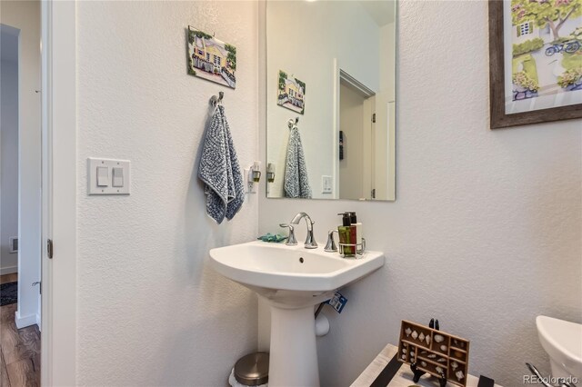 11253 Moondance Trl, Littleton, CO 80125 - half bathroom with toilet and wood finished floors