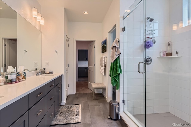 11253 Moondance Trl, Littleton, CO 80125 - bathroom with double vanity, a shower stall, recessed lighting, and tile patterned floors