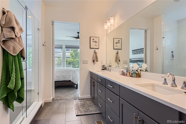 11253 Moondance Trl, Littleton, CO 80125 - ensuite bathroom with double vanity, a shower stall, tile patterned flooring, and baseboards