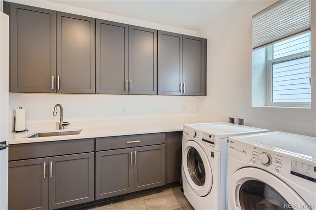 11253 Moondance Trl, Littleton, CO 80125 - laundry area featuring independent washer and dryer, cabinet space, and light tile patterned flooring