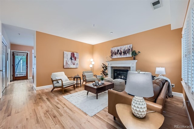 753 Pearl St, Boulder, CO 80302 - living area with a tile fireplace, light wood finished floors, and baseboards