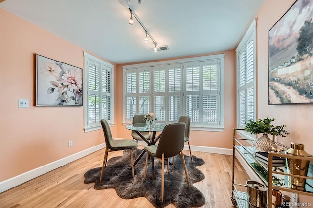 753 Pearl St, Boulder, CO 80302 - dining room featuring rail lighting, baseboards, and wood finished floors