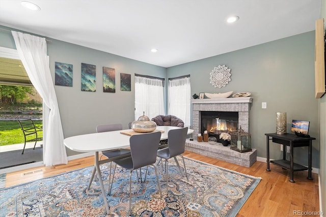 9494 Devonshire Pl, Highlands Ranch, CO 80126 - dining space featuring wood finished floors, a brick fireplace, baseboards, and recessed lighting