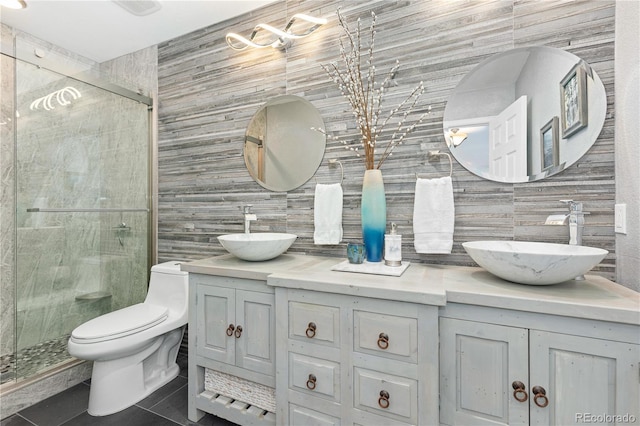 bathroom featuring toilet, an enclosed shower, tile walls, vanity, and tile patterned flooring