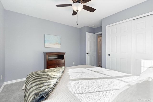 carpeted bedroom featuring ceiling fan and a closet