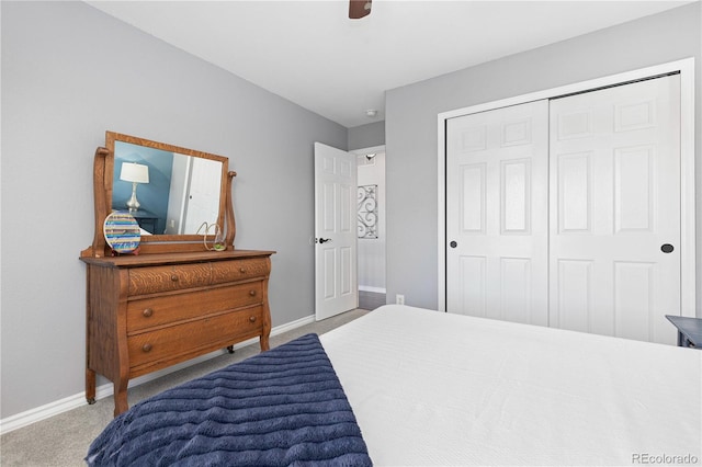 carpeted bedroom featuring ceiling fan and a closet