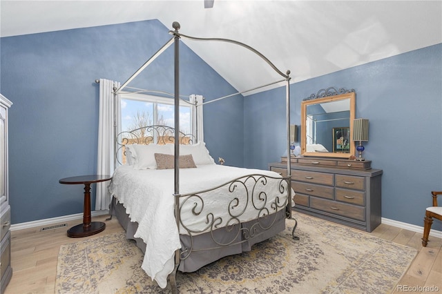 bedroom featuring lofted ceiling and light hardwood / wood-style floors