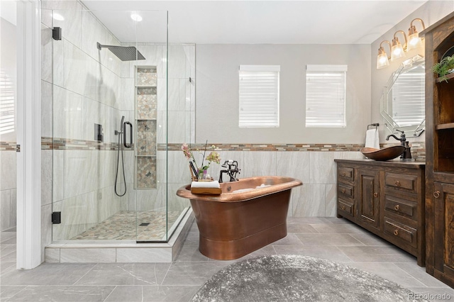 bathroom with vanity, separate shower and tub, and tile walls