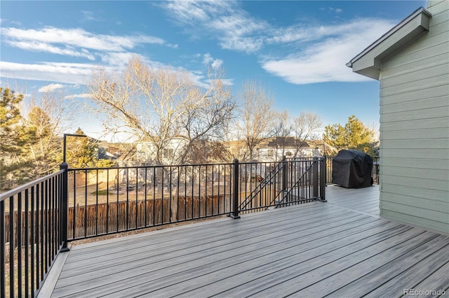 wooden terrace featuring a grill