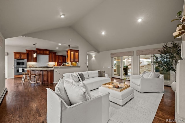 living room with high vaulted ceiling and dark hardwood / wood-style floors