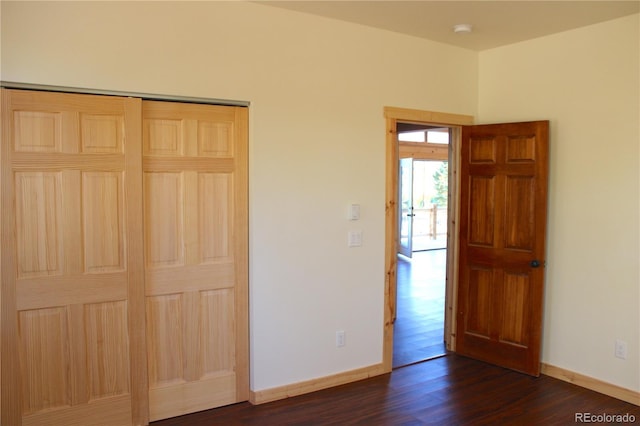 59 Whip Way, Hartsel, CO 80449 - unfurnished bedroom with dark wood-style floors, baseboards, and a closet
