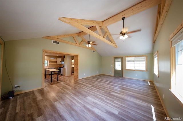 unfurnished living room with beam ceiling, ceiling fan, light hardwood / wood-style flooring, and high vaulted ceiling