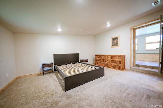 bedroom featuring light carpet