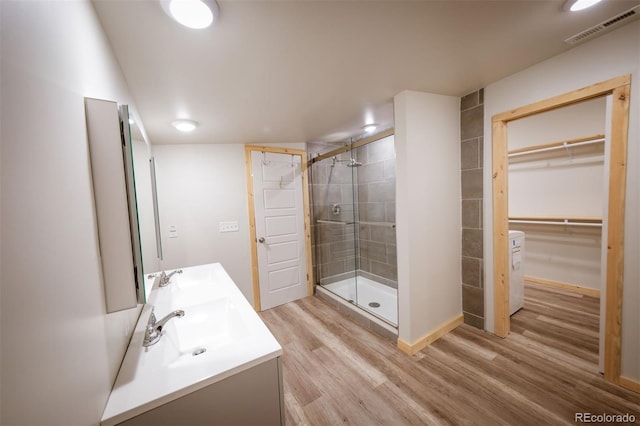 bathroom featuring hardwood / wood-style floors, vanity, and an enclosed shower