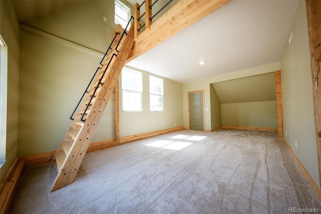 bonus room featuring carpet and vaulted ceiling