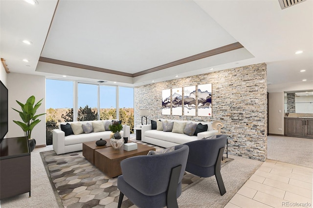 living room featuring ornamental molding and a raised ceiling