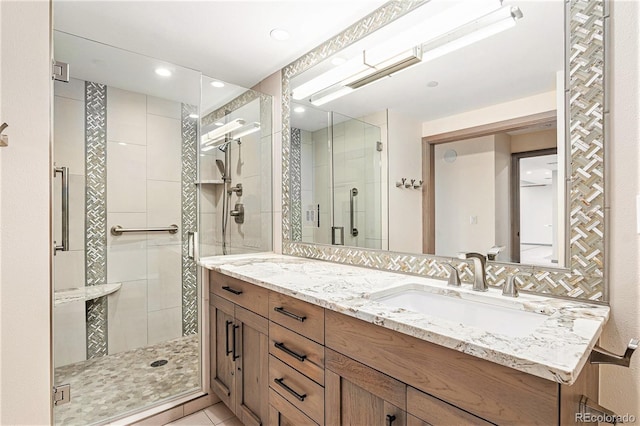 bathroom featuring an enclosed shower and vanity