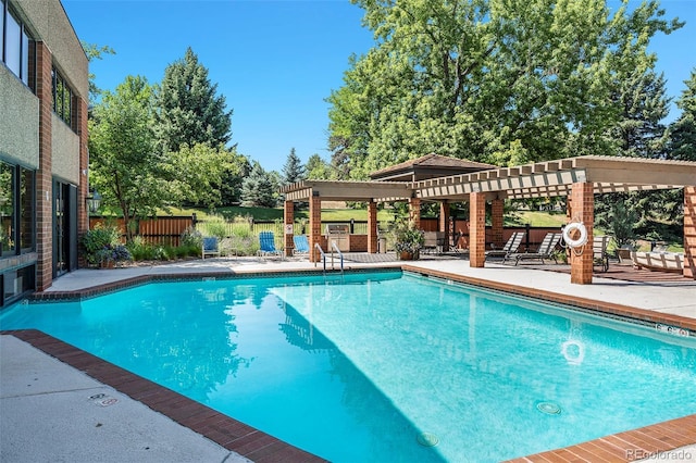 view of swimming pool with a pergola and a patio