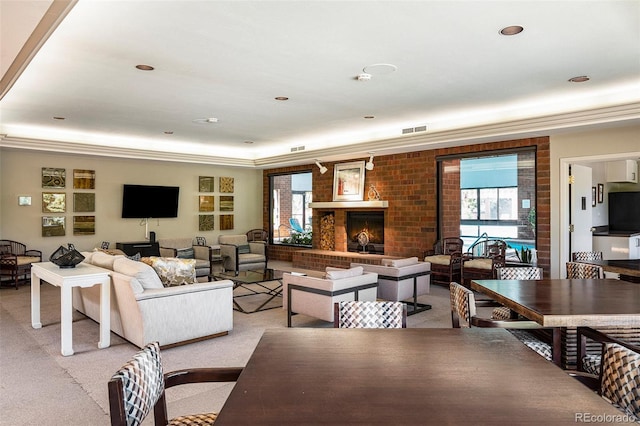 living room with light colored carpet, crown molding, and a fireplace