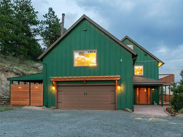 6066 Crawford Gulch Rd, Golden, CO 80403 - chalet / cabin featuring board and batten siding, driveway, and a garage