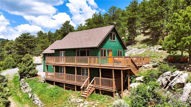 6066 Crawford Gulch Rd, Golden, CO 80403 - rear view of property with a deck, a shingled roof, and board and batten siding
