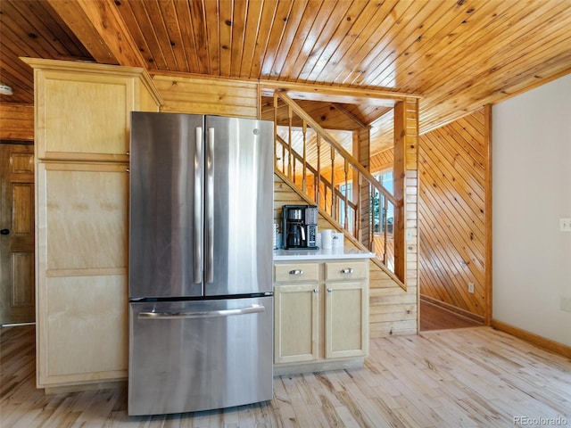 6066 Crawford Gulch Rd, Golden, CO 80403 - kitchen with freestanding refrigerator, wood walls, baseboards, wooden ceiling, and light wood-type flooring