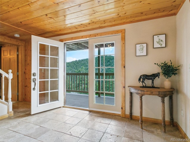 6066 Crawford Gulch Rd, Golden, CO 80403 - doorway featuring wooden ceiling, baseboards, and stone tile flooring