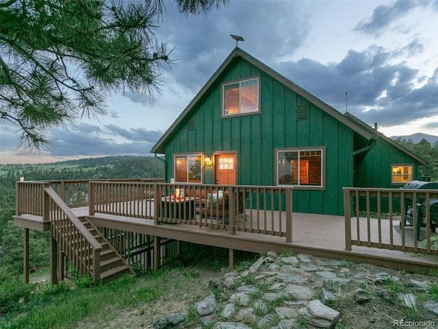 6066 Crawford Gulch Rd, Golden, CO 80403 - back of property with board and batten siding and a wooden deck