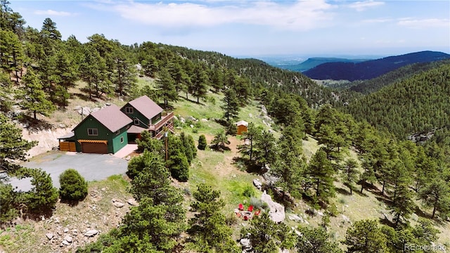 6066 Crawford Gulch Rd, Golden, CO 80403 - aerial view of property and surrounding area featuring a heavily wooded area and a mountainous background
