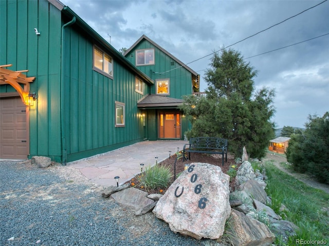 6066 Crawford Gulch Rd, Golden, CO 80403 - view of front of house featuring board and batten siding and a garage
