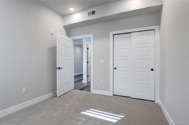 unfurnished bedroom featuring carpet floors and a closet