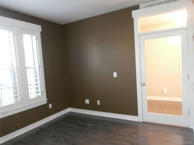 empty room featuring dark hardwood / wood-style flooring