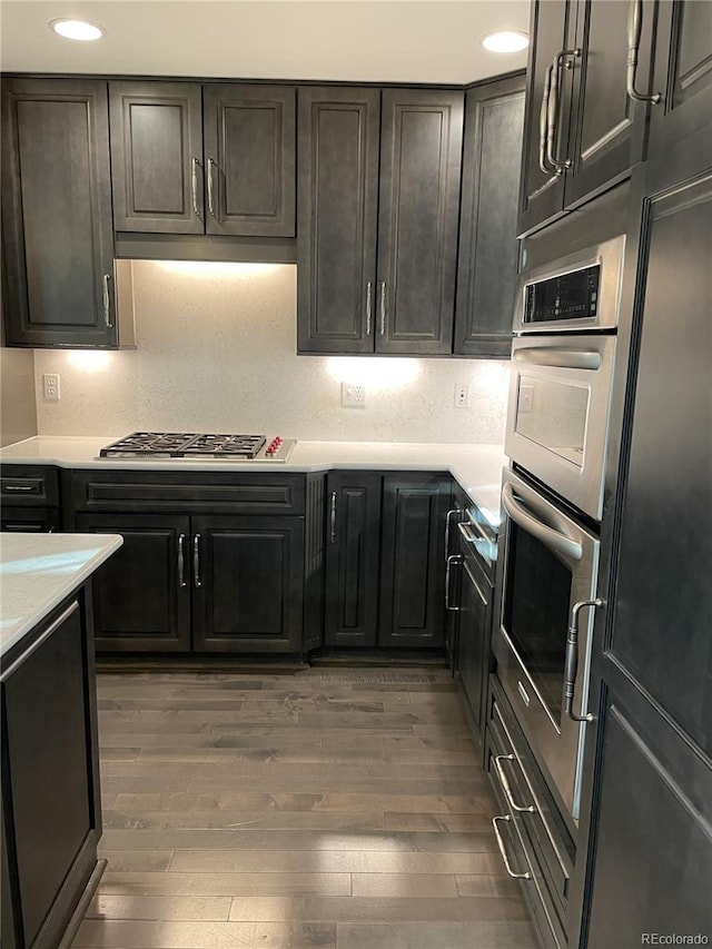 kitchen with dark hardwood / wood-style flooring and stainless steel appliances