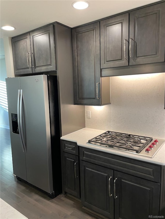 kitchen featuring appliances with stainless steel finishes and dark wood-type flooring