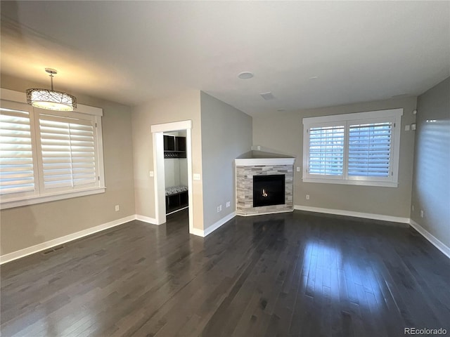 unfurnished living room featuring dark hardwood / wood-style flooring and a fireplace