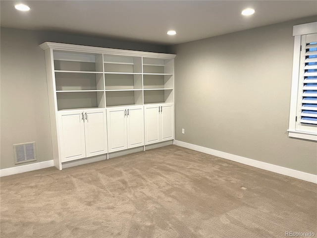 unfurnished room with light colored carpet