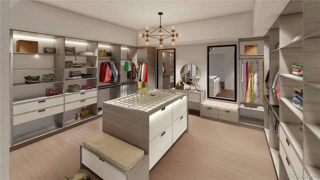 6834 S Ensenada St, Aurora, CO 80016 - walk in closet featuring a chandelier and light wood finished floors