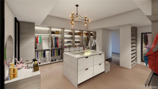 6834 S Ensenada St, Aurora, CO 80016 - walk in closet with a chandelier and light wood-style floors