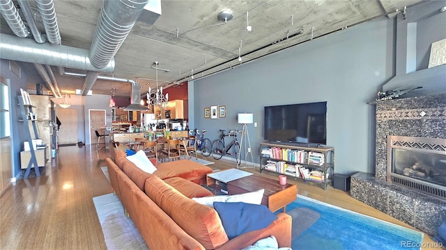 living room with hardwood / wood-style flooring and a premium fireplace