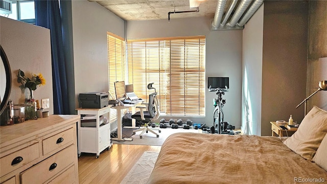 bedroom featuring multiple windows and light wood-type flooring